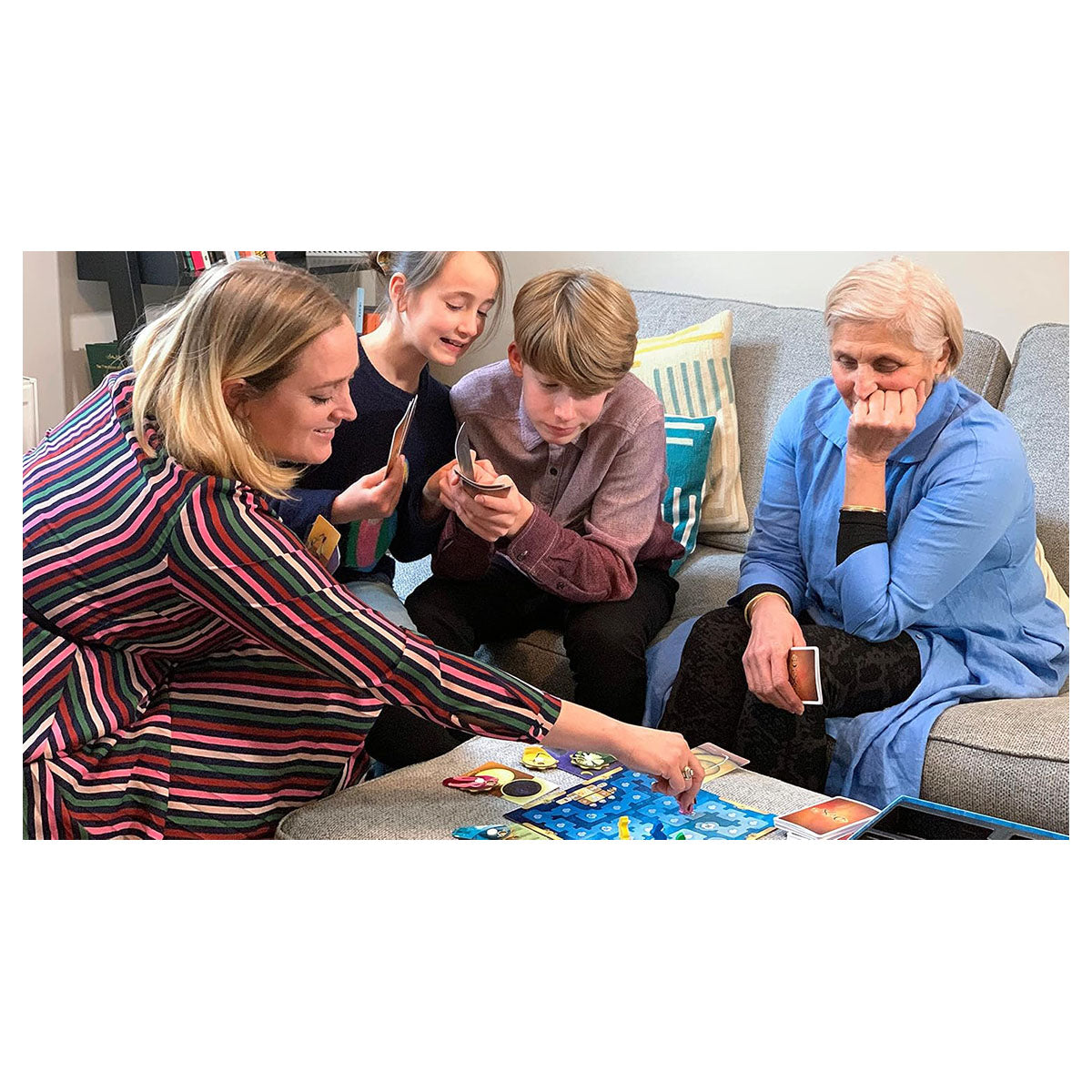 Family playing Dixit Expansion Quest